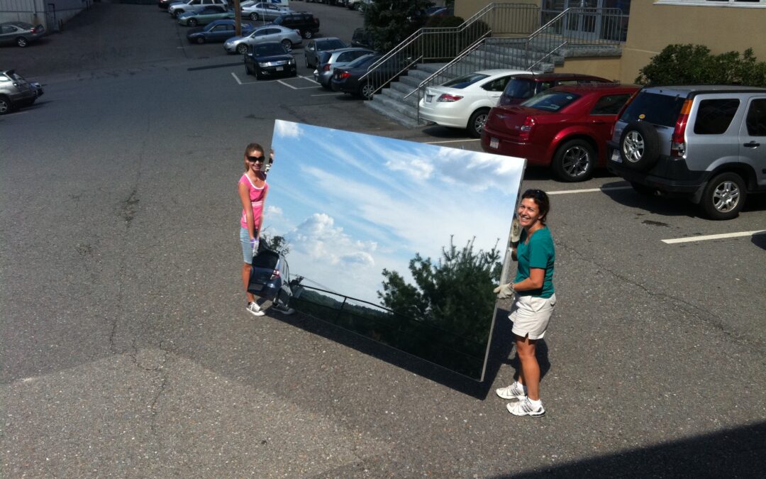 Glassless mirror panel being handled outdoors, shatterproof and lightweight mirror alternative