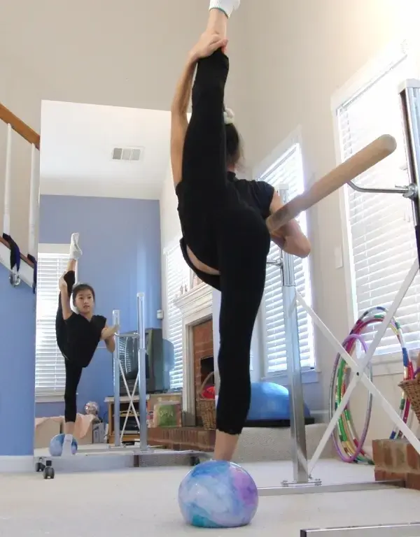 Dancer practicing in a home studio using a Mirrorlite® glassless mirror.
