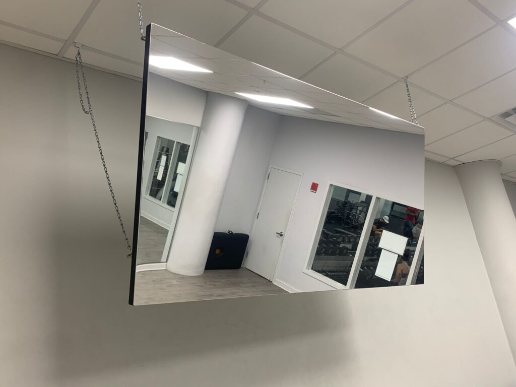 Ceiling hanging glassless mirror on ceiling grid attachments